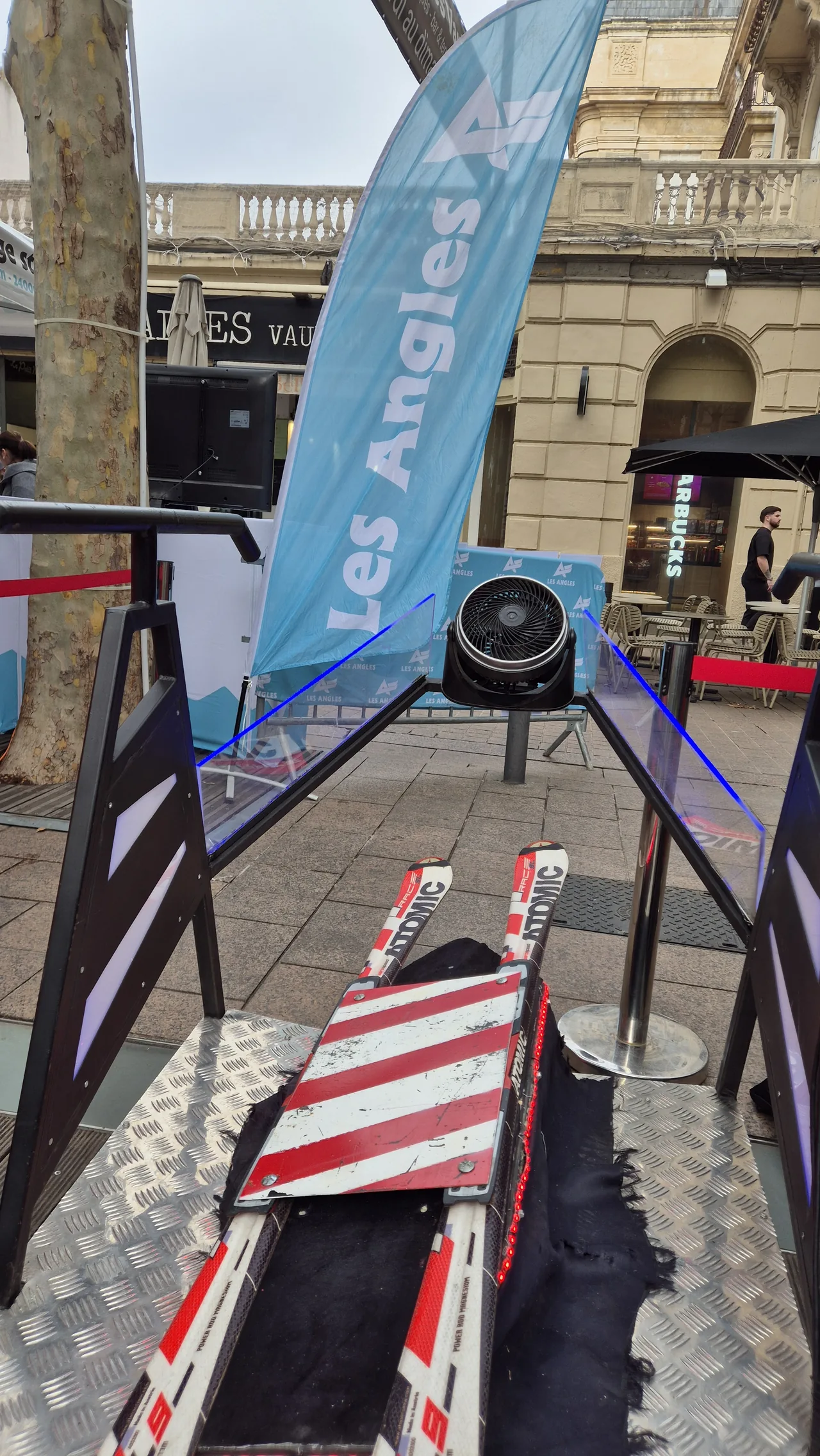 Parade aux flambeaux Neiges Catalanes en cours dans la rue commerciale de Perpignan avec simulateur ski VR