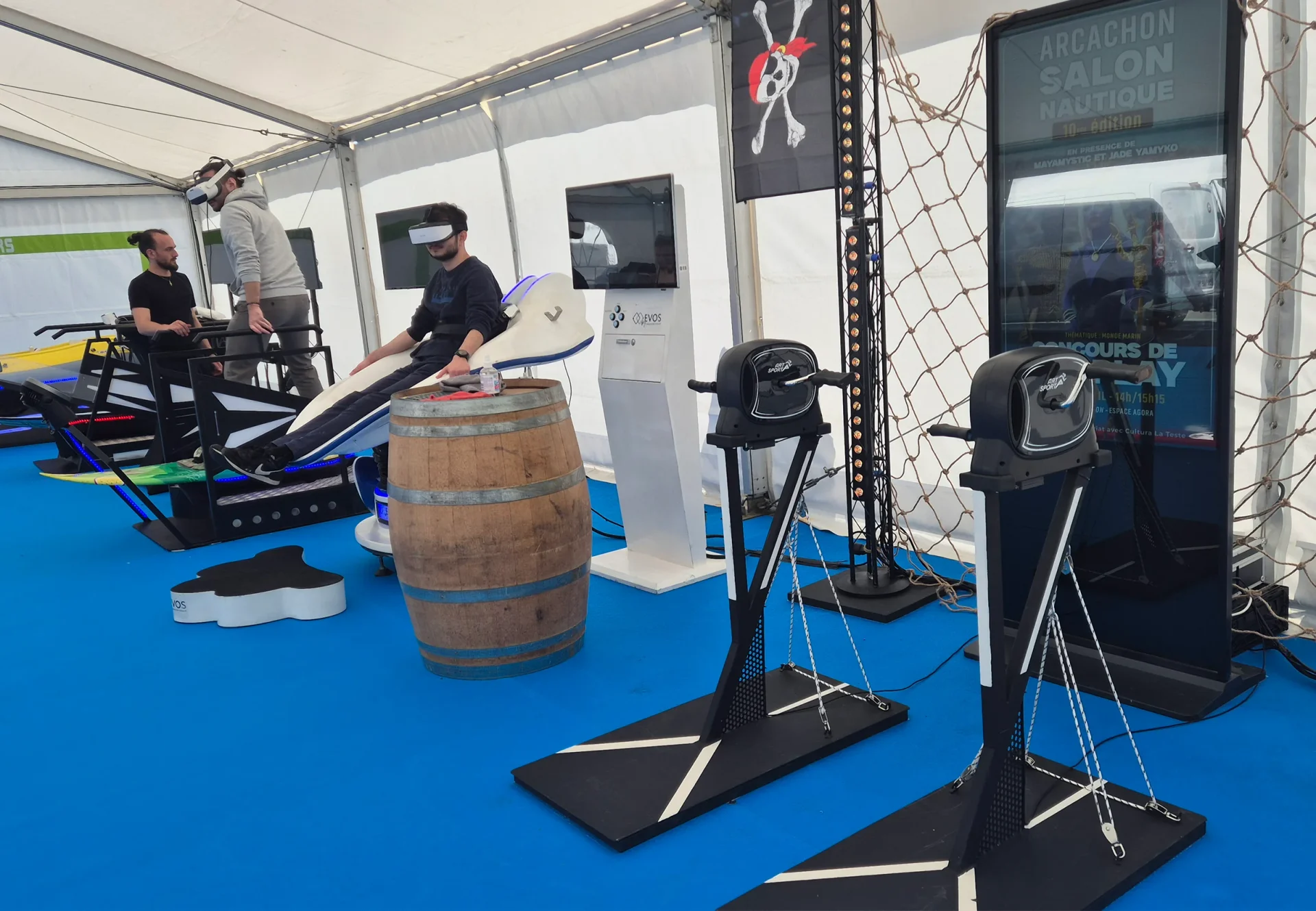 Espace gaming avec simulateurs de surf et kayak VR sous chapiteau