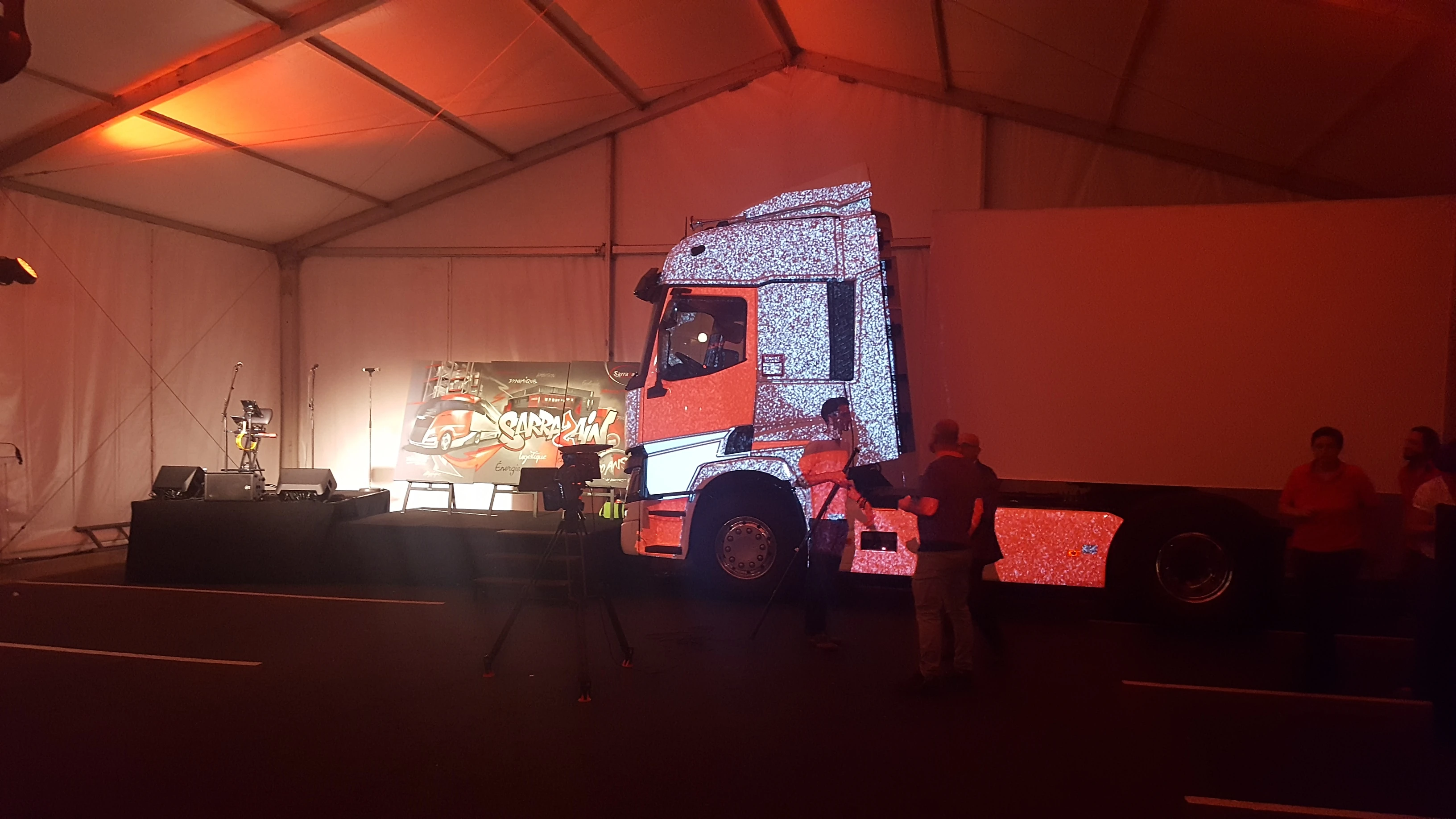 Dévoilement scénographié du camion neuf Transports Sarrazain en livrée graphique sous chapiteau à Albi
